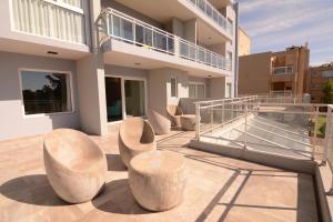 a balcony of a building with two chairs on it at IQU Apart in Las Gaviotas