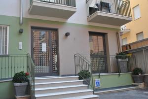 a building with stairs in front of a door at Hotel Residence Laigueglia in Laigueglia