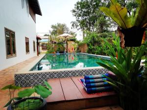 a swimming pool in the middle of a yard at ANGKOR DINO B&B in Siem Reap