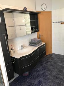a bathroom with a sink and a mirror at Wieko Ferienwohnungen in Plauen +68 photos