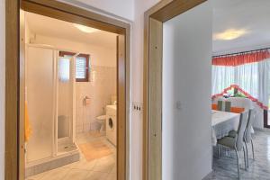 a door leading to a dining room with a table at Apartman D&D, Dvorine 63 in Banjole +30 photos