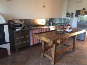 cocina con mesa de madera frente a una estufa en Bed & Breakfast Col Mazzet, en Belluno