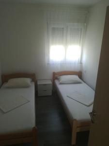 Postel nebo postele na pokoji v ubytování Apartmani Ivka