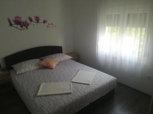 Postel nebo postele na pokoji v ubytování Apartmani Ivka
