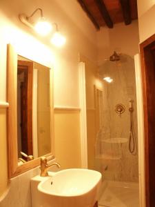 a bathroom with a sink and a shower at Galleria Ars Apua in Carrara