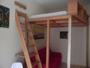 a bunk bed with a ladder in a room at Casa Vacanze Monachy in Merano