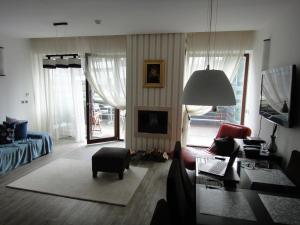 a living room with a couch and a chair at Chambres Mountain in Poiana Brasov