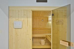 a wooden sauna with a door in a room at Anatoli Hotel in Naxos Chora