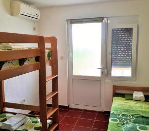 a room with two bunk beds and a window at Sea Cottage Studios in Budva