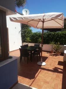 a patio with a table and an umbrella at Isabel in Crotone