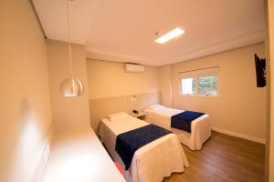Ένα ή περισσότερα κρεβάτια σε δωμάτιο στο Hiber Hotel - Acesso a Chapecó