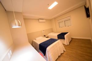 Ένα ή περισσότερα κρεβάτια σε δωμάτιο στο Hiber Hotel - Acesso a Chapecó