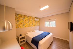 Ένα ή περισσότερα κρεβάτια σε δωμάτιο στο Hiber Hotel - Acesso a Chapecó