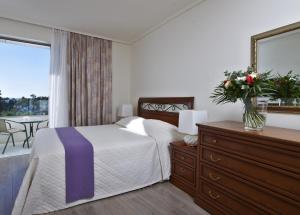 Postel nebo postele na pokoji v ubytování Amarilia Hotel