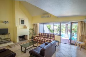 a living room with a couch and a fireplace at Capitalmoura Mouragolf Village in Vilamoura