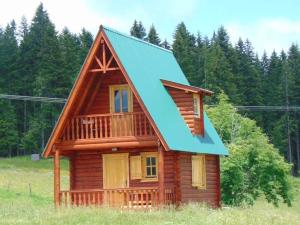 a small log cabin with a blue roof at Holiday Home Jabucilo in Žabljak