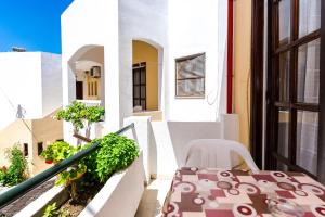 a balcony with a table and chairs on a building at Erato Hotel Apartments in Rethymno