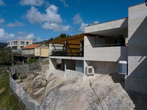 a house on top of a large rock at Desconectate in Aldán