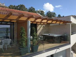a patio with a pergola on a house at Desconectate in Aldán
