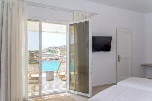 a bedroom with a bed and a view of the ocean at Super Paradise Hotel in Super Paradise Beach