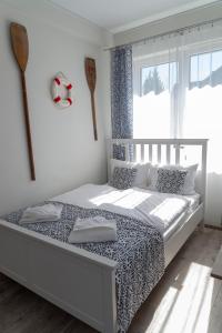 a bedroom with a bed and a large window at Apartamenty Mewa in Międzyzdroje