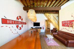 a living room with a couch and a tv at Suntrap Hostel in Lagos