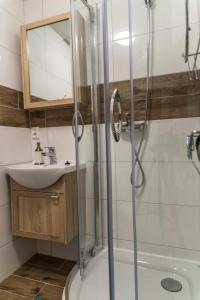 a bathroom with a shower and a sink at Marina House Apartments in Międzyzdroje