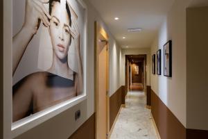 a hallway with paintings of women on the walls at Zebra Naviglio in Milan