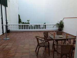 a patio with a table and chairs and a chalkboard at Casa sol in Vélez-Málaga