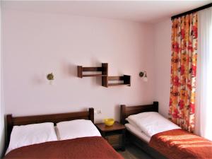 a bedroom with two beds and a window at NEMO 2 in Karwia