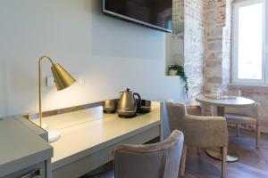a kitchen with a counter with a table and chairs at Riva Palace in Split