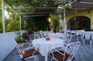 a group of tables and chairs on a patio at Hotel Europa in Ischia