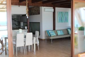 a dining room and kitchen with a table and chairs at Blumarine Dh in Formia +25 photos