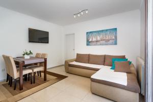 a living room with a couch and a table at Apartments Ostojic in Krk