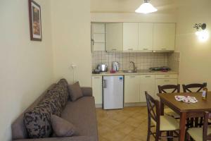 a living room and kitchen with a couch and a table at Kerveli Luxury Villa in Kerveli