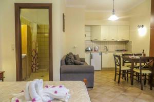 a living room and kitchen with a couch and a table at Kerveli Luxury Villa in Kerveli