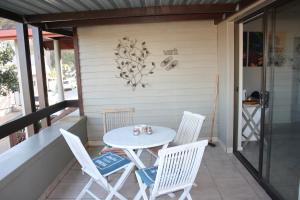 a white table and chairs on a porch at Old Post Office Lodge in Wilderness
