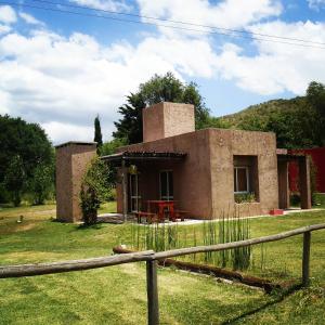 a small house with a fence in front of it at Los Bambues Cabañas in El Volcán