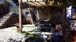 un patio con macetas y un edificio de piedra en Casa Millin en Borzonasca