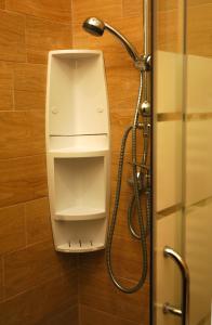 a shower stall with a dispenser in a bathroom at Hotel Sonenga in Menaggio
