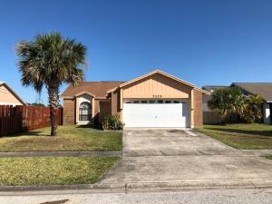 a house with a garage and a palm tree at Laguna Villas in Kissimmee