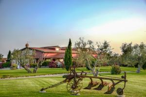 a park with a bench in the grass at La Pecora Ladra Appartamenti in Montalto di Castro