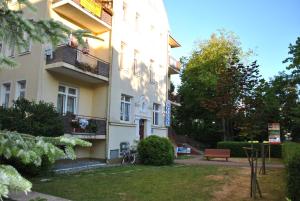 a building with a park in front of it at Pokoje z łazienkami in Kołobrzeg