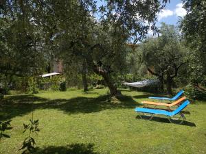two lounge chairs in a yard with a hammock at House Christie in Chrysi Ammoudia