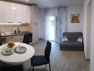 a kitchen and a living room with a table and chairs at Niko apartment in Jelsa
