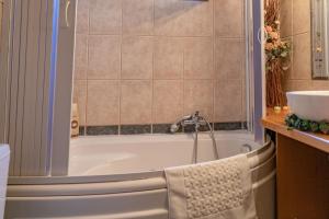 a bathroom with a tub and a sink at Villa Umami in Makri +35 photos