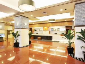a lobby with potted plants in a building at APA Hotel Sapporo Susukino Ekinishi in Sapporo