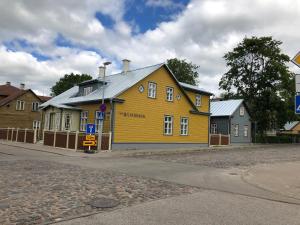 a yellow building on the side of a street at Silbernagel Villa in Kuressaare