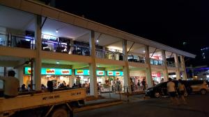 a group of people standing outside of a building at night at Khalil's Horizons 101 Studio Type Condominium in Cebu City