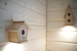 a wooden birdhouse and a light on a shelf at Cubryna in Zakopane